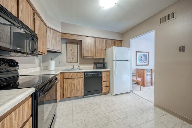 551 Sloop Dr Unit 61, Mccandless, PA 15237 - kitchen featuring black appliances, light countertops, a sink, and baseboards
