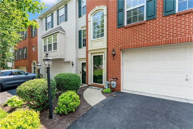 2000 Michael Dr, Baldwin Boro, PA 15227 - view of front of house featuring an attached garage, asphalt driveway, and brick siding