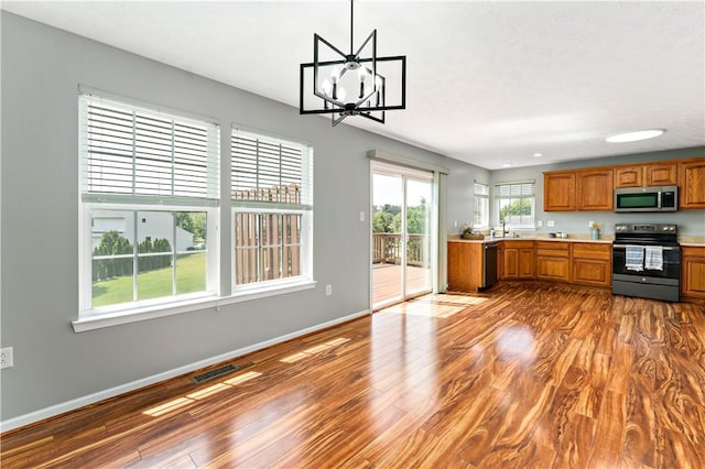 2000 Michael Dr, Baldwin Boro, PA 15227 - kitchen with appliances with stainless steel finishes, brown cabinets, a sink, light countertops, and wood finished floors