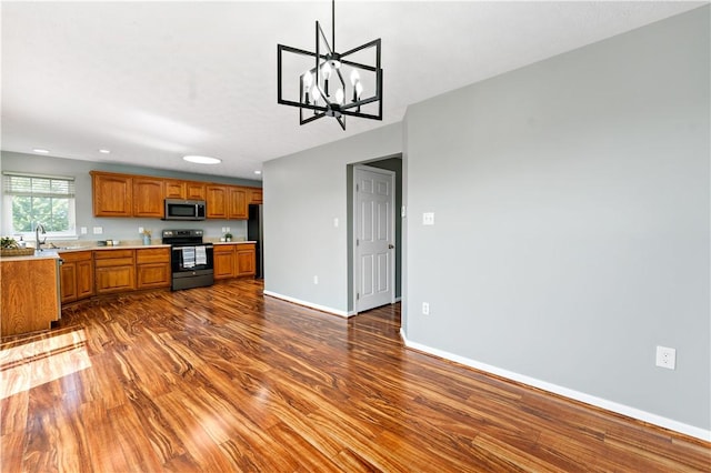 2000 Michael Dr, Baldwin Boro, PA 15227 - kitchen with stainless steel appliances, brown cabinetry, light countertops, dark wood-type flooring, and recessed lighting