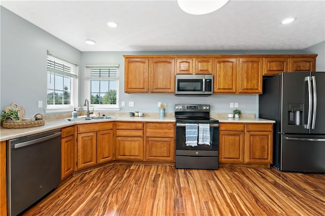 2000 Michael Dr, Baldwin Boro, PA 15227 - kitchen featuring appliances with stainless steel finishes, a sink, light countertops, wood finished floors, and recessed lighting