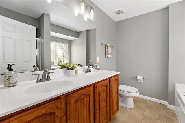 2000 Michael Dr, Baldwin Boro, PA 15227 - bathroom with double vanity, toilet, a bath, baseboards, and tile patterned floors