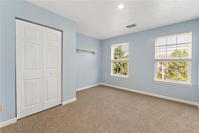 2000 Michael Dr, Baldwin Boro, PA 15227 - unfurnished bedroom with carpet flooring, baseboards, a closet, and a textured ceiling