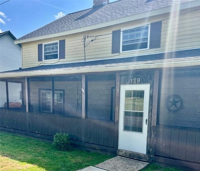 128 Main St, Perry Twp Fay, PA 15473 - view of front facade featuring a chimney, roof with shingles, and a sunroom