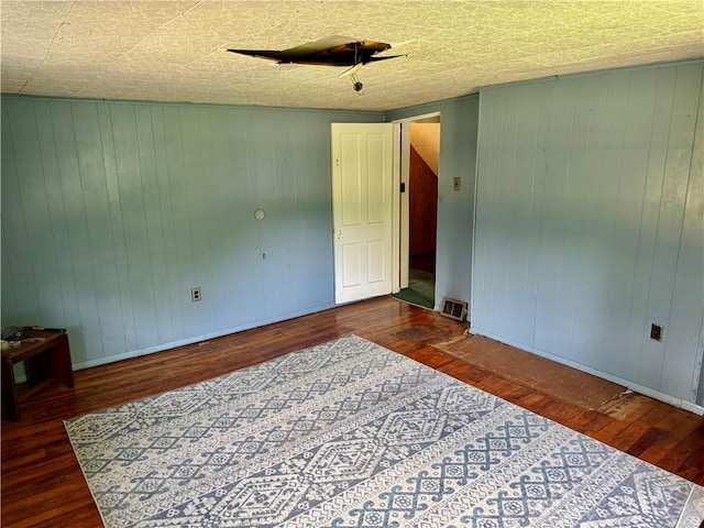 128 Main St, Perry Twp Fay, PA 15473 - empty room featuring wood finished floors and wooden walls