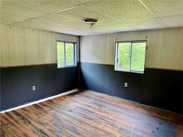 128 Main St, Perry Twp Fay, PA 15473 - spare room featuring hardwood / wood-style floors, wooden walls, a paneled ceiling, and wainscoting