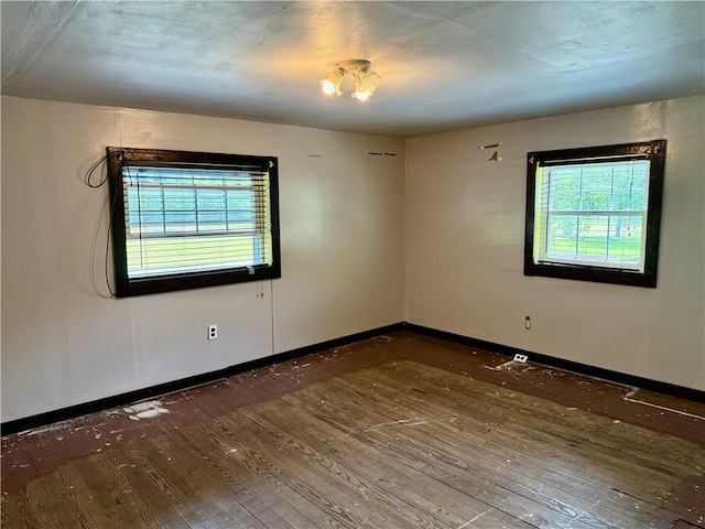 128 Main St, Perry Twp Fay, PA 15473 - unfurnished room with plenty of natural light, wood-type flooring, and baseboards