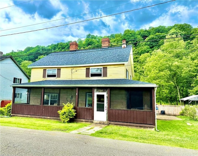 128 Main St, Perry Twp Fay, PA 15473 - view of front of property featuring a sunroom, a chimney, and roof with shingles