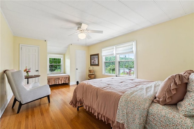 1200 River Rd, Beaver, PA 15009 - bedroom with wood finished floors, ceiling fan, radiator, and baseboards