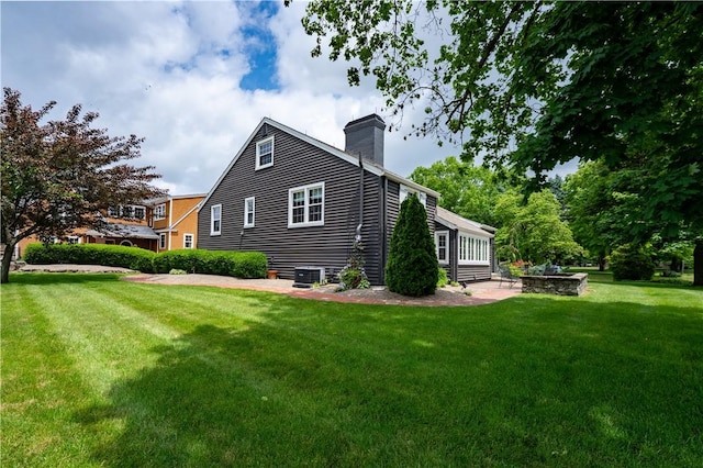 1200 River Rd, Beaver, PA 15009 - view of side of property with a chimney, a yard, and central AC unit