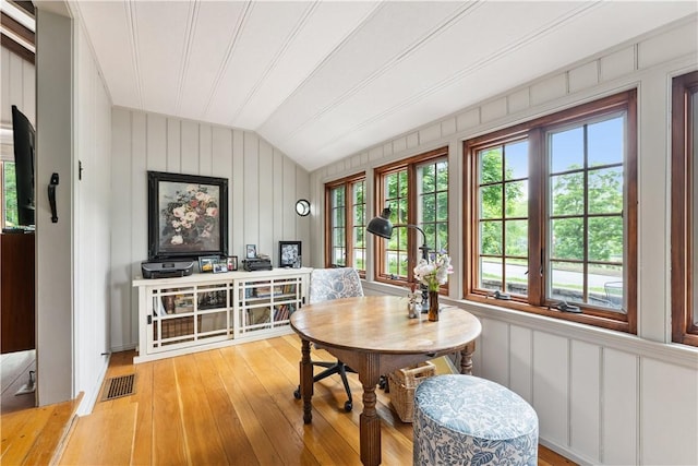 1200 River Rd, Beaver, PA 15009 - dining space with vaulted ceiling, light wood-style flooring, healthy amount of natural light, and a decorative wall