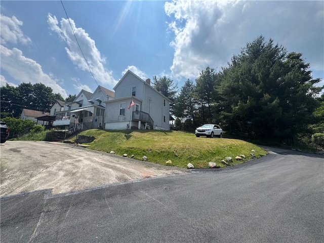 423 Lowell St, Vandergrift Wml, PA 15690 - view of home's exterior featuring a yard and a chimney