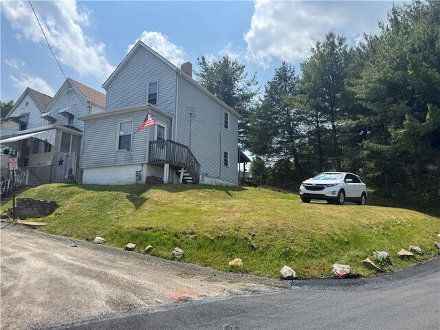 423 Lowell St, Vandergrift Wml, PA 15690 - view of front of house with a chimney and a front lawn