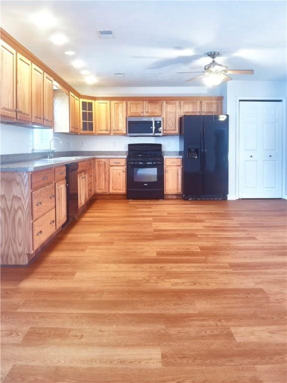 121 Columbus Dr, Punxsutawney Area School District, PA 15767 - kitchen featuring black appliances, light wood-style flooring, ceiling fan, a sink, and light brown cabinetry