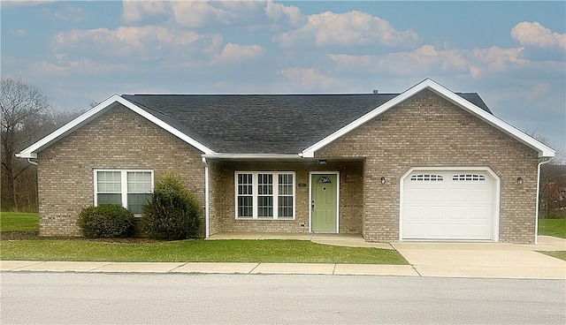 121 Columbus Dr, Punxsutawney Area School District, PA 15767 - view of front of home with brick siding, driveway, an attached garage, and a shingled roof