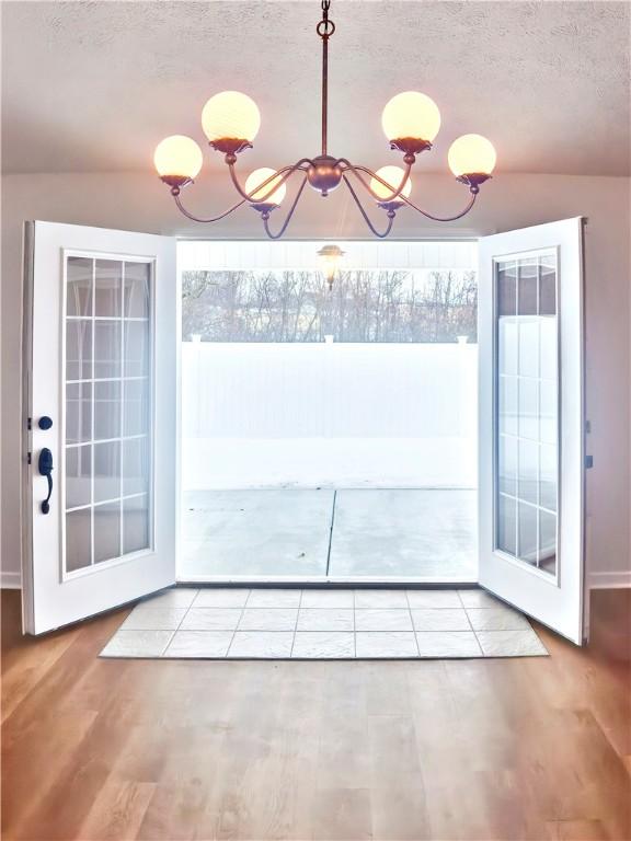 121 Columbus Dr, Punxsutawney Area School District, PA 15767 - doorway featuring a chandelier, wood finished floors, and a textured ceiling