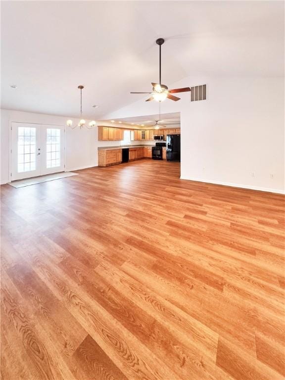 121 Columbus Dr, Punxsutawney Area School District, PA 15767 - unfurnished living room featuring light wood-type flooring, ceiling fan, french doors, lofted ceiling, and a chandelier