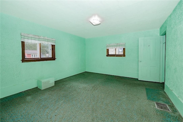 721 W Mahoning St, Punxsutawney Area School District, PA 15767 - unfurnished room featuring plenty of natural light, dark carpet, and a textured wall