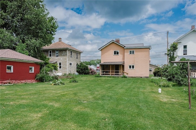 721 W Mahoning St, Punxsutawney Area School District, PA 15767 - rear view of property featuring a sunroom, a yard, and a chimney