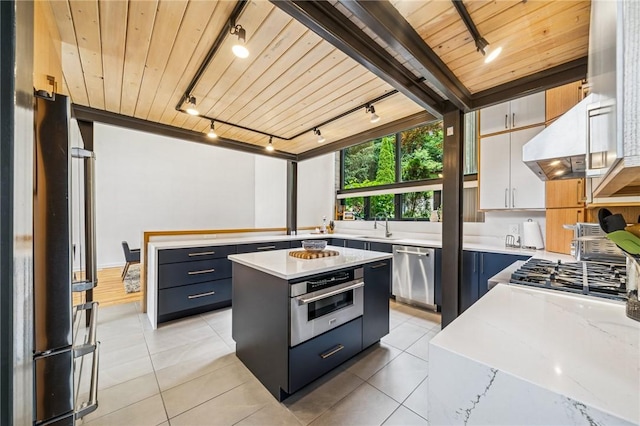 340 Lakewood Rd, Unity Twp, PA 15601 - kitchen featuring rail lighting, stainless steel appliances, wooden ceiling, under cabinet range hood, and a sink