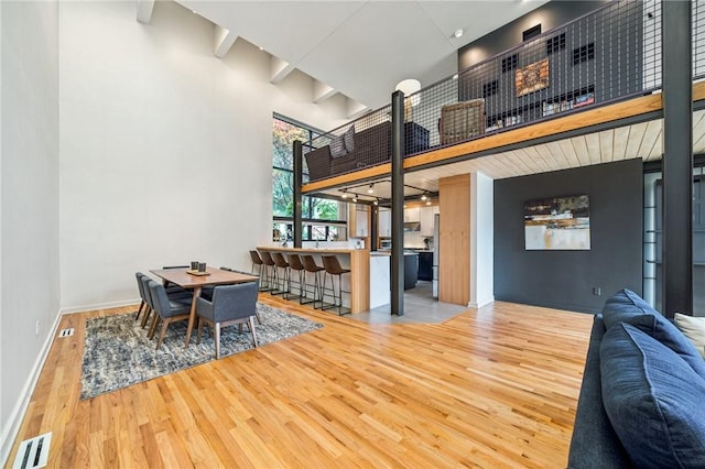 340 Lakewood Rd, Unity Twp, PA 15601 - dining area featuring wood finished floors, baseboards, and a towering ceiling