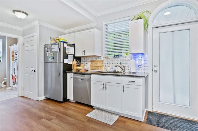 1503 Kenberma Ave, Beechview, PA 15216 - kitchen with stainless steel appliances, light wood-style flooring, white cabinetry, backsplash, and ornamental molding