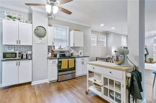 1503 Kenberma Ave, Beechview, PA 15216 - kitchen featuring appliances with stainless steel finishes, ornamental molding, light wood-type flooring, decorative backsplash, and a ceiling fan