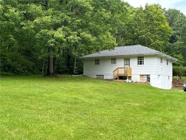428 Muddy Creek Dr, Brady Twp But, PA 16057 - rear view of house with a yard, a wooded view, and roof with shingles