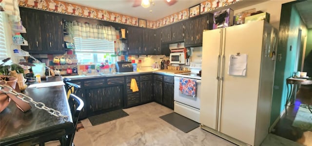132 Sherwood St, Belle Vernon Fay, PA 15012 - kitchen featuring white appliances, a ceiling fan, light countertops, and dark brown cabinets