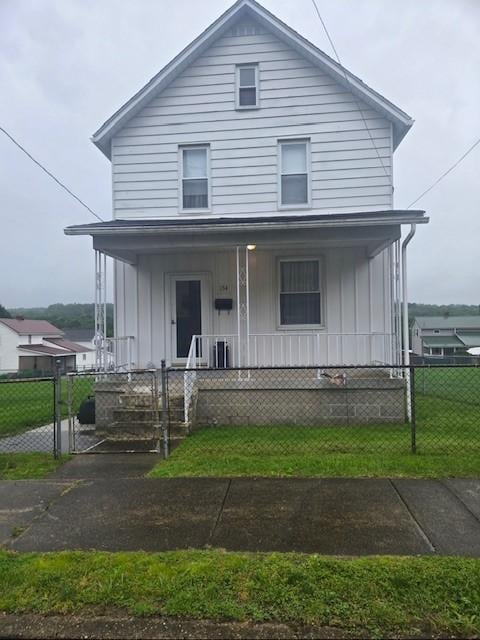 134 E Harvey Ave, Masontown, PA 15461 - american foursquare style home with a porch, board and batten siding, and a fenced front yard
