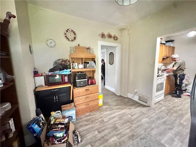 311 1st Ave, Belle Vernon Fay, PA 15012 - kitchen with light wood-style floors, white range oven, light countertops, and black microwave