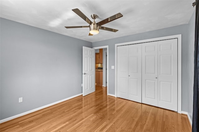3315 Crestview Dr N, Versailles, PA 15137 - unfurnished bedroom featuring baseboards, light wood-style floors, a closet, and a ceiling fan