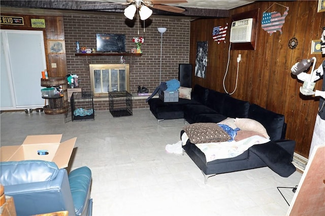 5 Moyer Ave, Scottdale, PA 15683 - living area featuring ceiling fan, wooden walls, a brick fireplace, and a wall unit AC