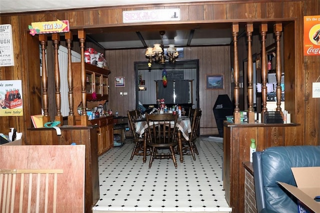 5 Moyer Ave, Scottdale, PA 15683 - dining area featuring wood walls, a chandelier, and tile patterned floors