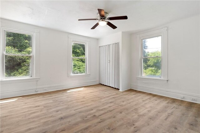 1567 Princeton Blvd, Wilkinsburg, PA 15221 - unfurnished bedroom featuring multiple windows, light wood-style flooring, baseboards, and a ceiling fan