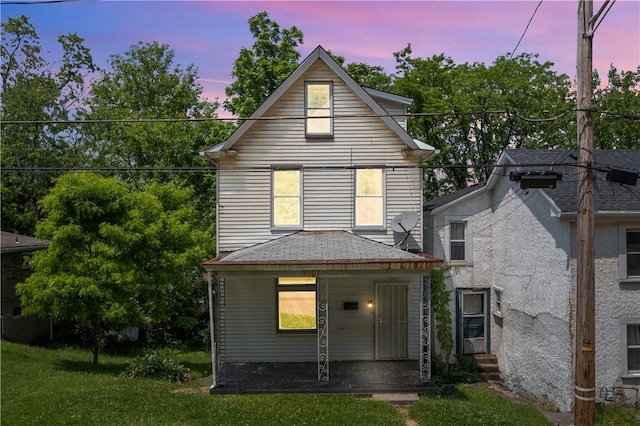 1567 Princeton Blvd, Wilkinsburg, PA 15221 - back of house at dusk featuring a porch and a shingled roof