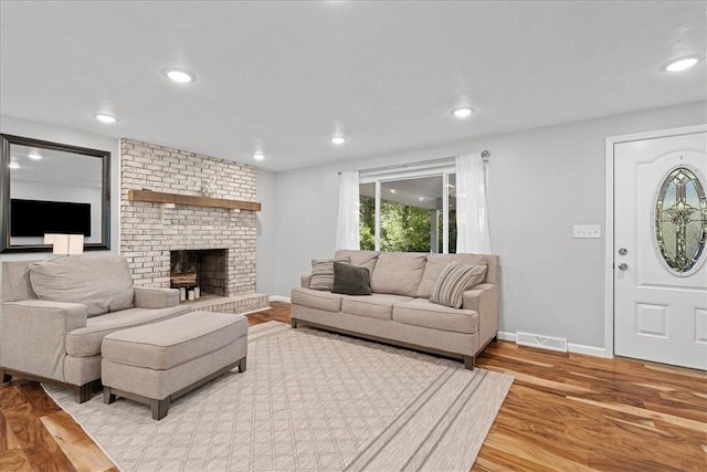 259 Old Blackhawk Rd, Chippewa Twp, PA 15010 - living area with wood finished floors, baseboards, a brick fireplace, and recessed lighting
