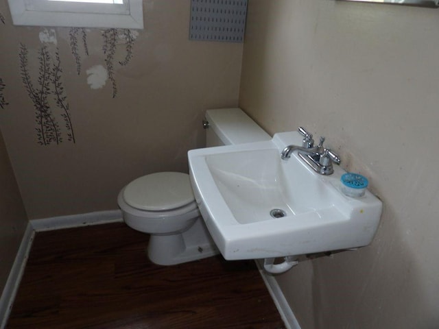 2042 Madison St, Hermitage, PA 16148 - bathroom with toilet, a sink, wood finished floors, and baseboards
