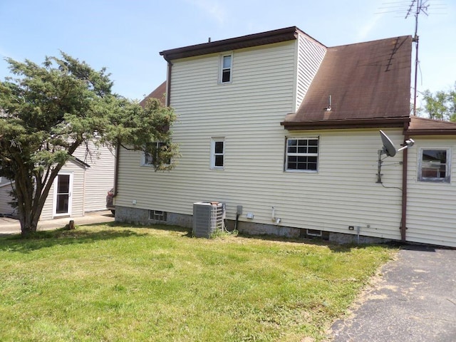 2042 Madison St, Hermitage, PA 16148 - view of side of home with central AC, a yard, and roof with shingles