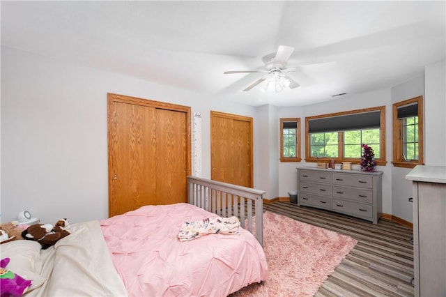 258 Smith Rd, Connoquenessing Twp, PA 16053 - bedroom with two closets, baseboards, a ceiling fan, and wood finished floors