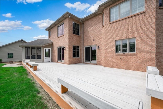 258 Smith Rd, Connoquenessing Twp, PA 16053 - rear view of property with a wooden deck, brick siding, a sunroom, and a lawn