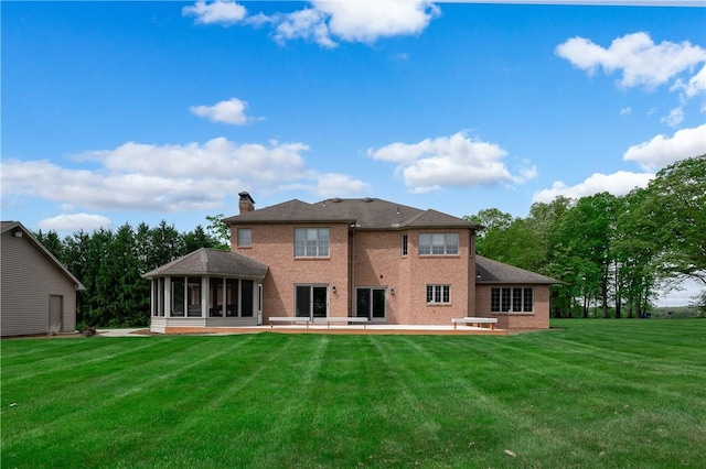 258 Smith Rd, Connoquenessing Twp, PA 16053 - back of property with a sunroom, a yard, a chimney, a patio, and brick siding