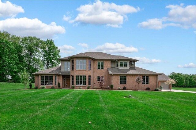 258 Smith Rd, Connoquenessing Twp, PA 16053 - rear view of house with brick siding, a lawn, a garage, and concrete driveway