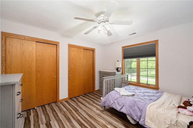 258 Smith Rd, Connoquenessing Twp, PA 16053 - bedroom with two closets, wood finished floors, and ceiling fan