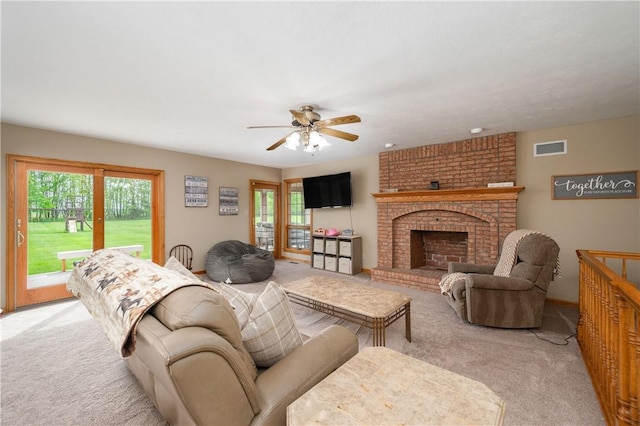258 Smith Rd, Connoquenessing Twp, PA 16053 - living area with light carpet, plenty of natural light, a ceiling fan, and a fireplace