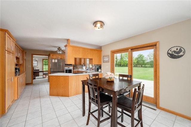 258 Smith Rd, Connoquenessing Twp, PA 16053 - dining space featuring light tile patterned flooring, baseboards, and ceiling fan