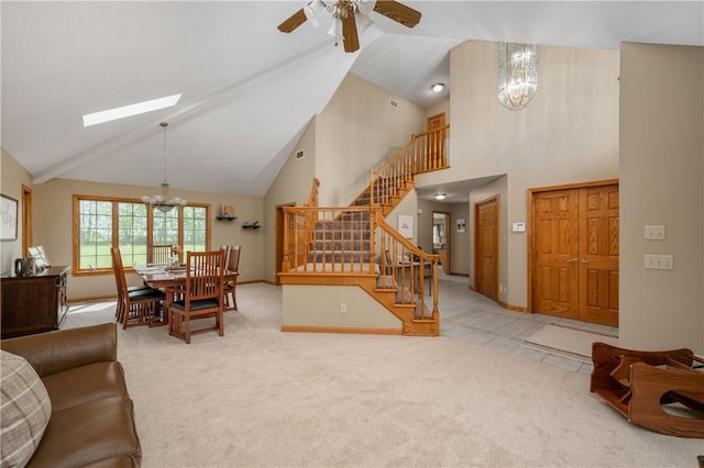 258 Smith Rd, Connoquenessing Twp, PA 16053 - carpeted living area with a chandelier, stairs, high vaulted ceiling, a ceiling fan, and a skylight