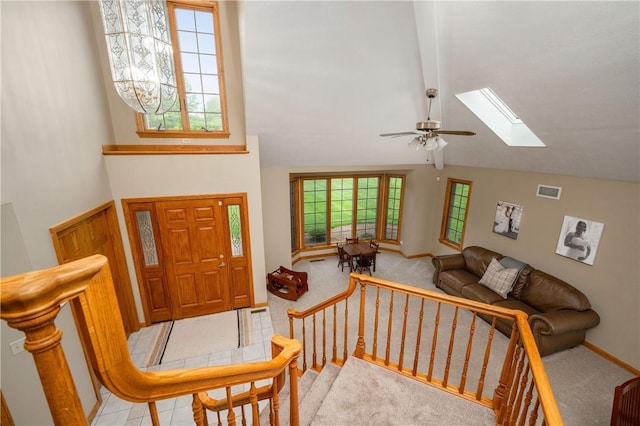 258 Smith Rd, Connoquenessing Twp, PA 16053 - foyer featuring a skylight, light colored carpet, ceiling fan, baseboards, and high vaulted ceiling