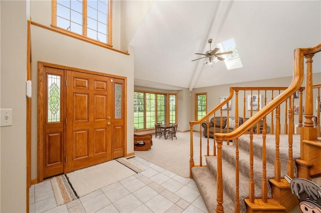 258 Smith Rd, Connoquenessing Twp, PA 16053 - entrance foyer featuring high vaulted ceiling, light colored carpet, light tile patterned flooring, stairs, and a skylight