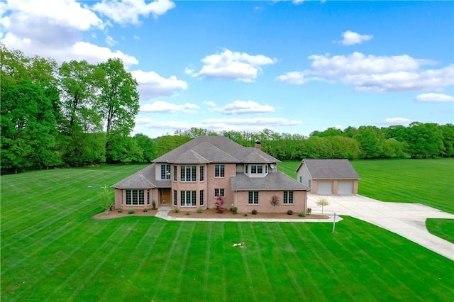 258 Smith Rd, Connoquenessing Twp, PA 16053 - view of front facade with an outdoor structure, a detached garage, a front lawn, and stucco siding